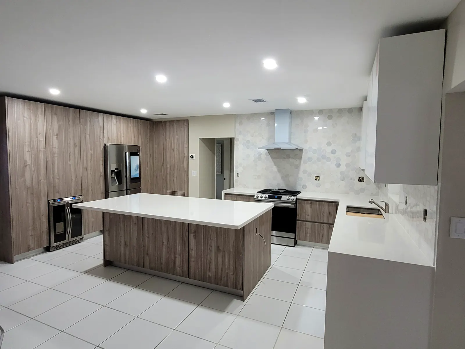 Walnut woodgrain custom kitchen with white island built by Designs and Cabinets in Miami